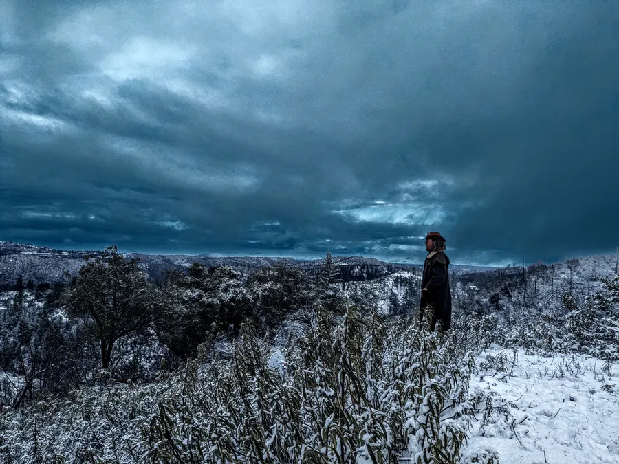 Jesper Jurcenoks contemplating on his snow covered mountain top